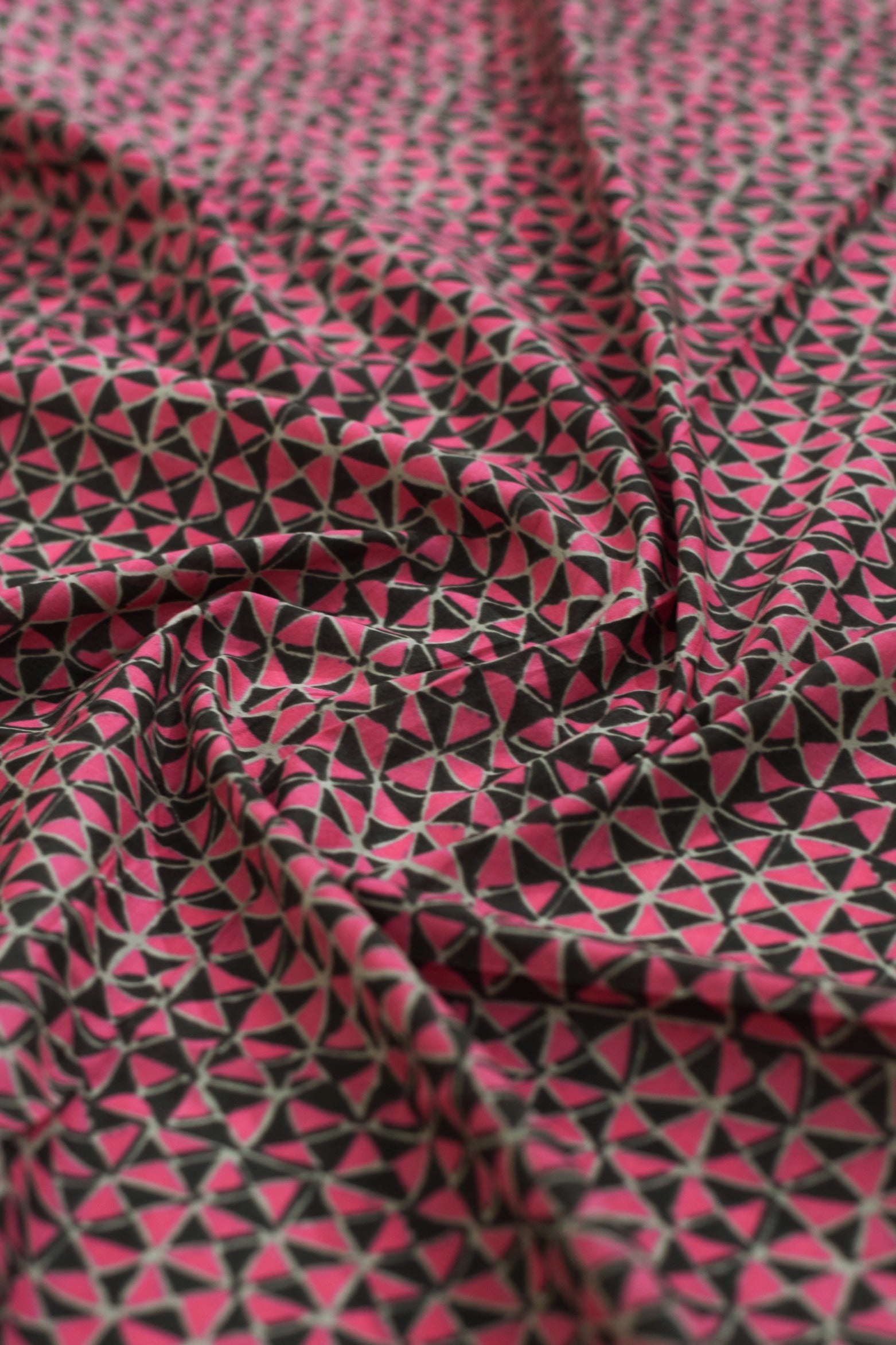 Pink and black geometric patterned fabric.
