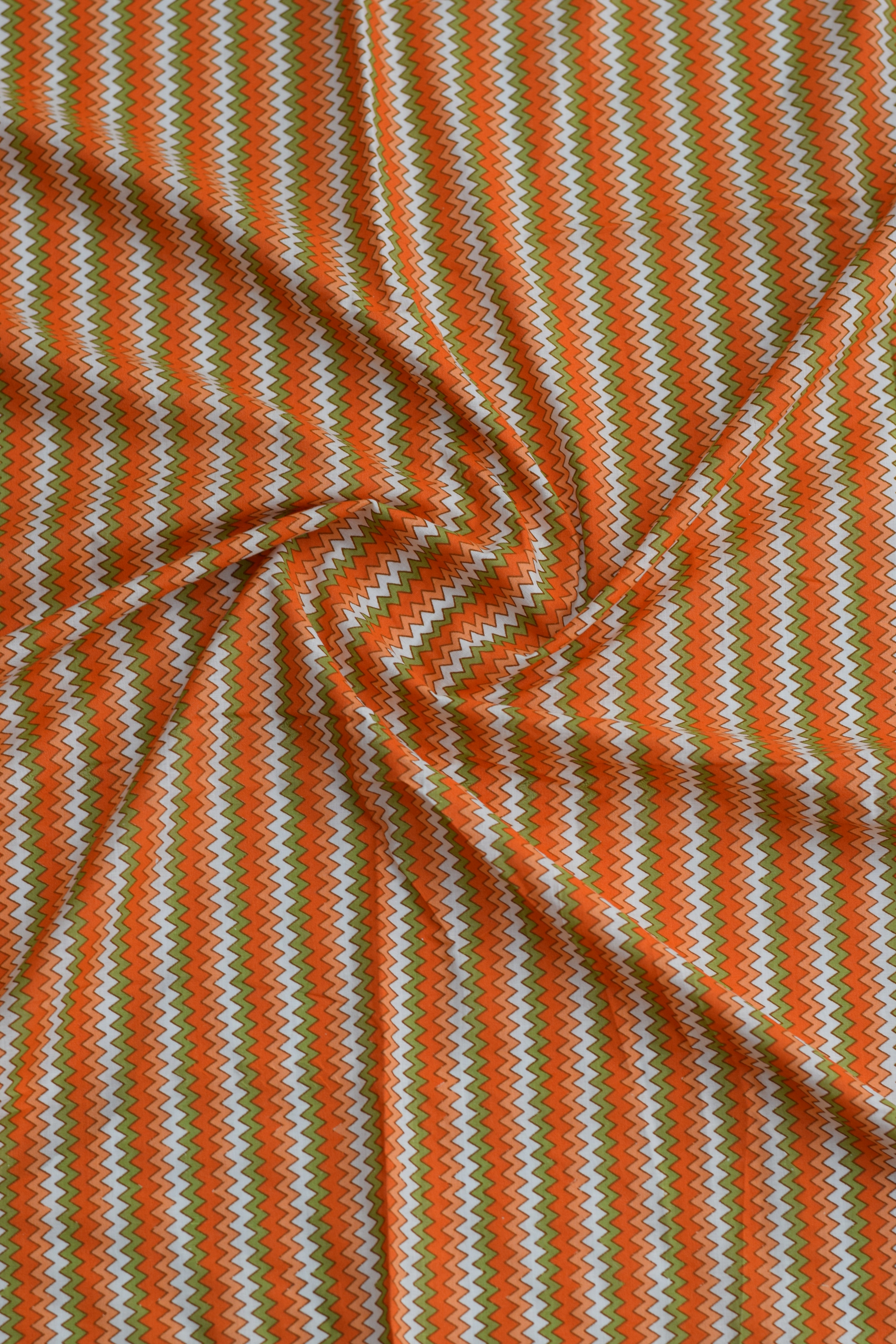 Chevron pattern fabric with orange and green stripes.