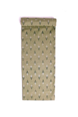 Fabric with a subtle sage green base featuring soft ikat-style motifs in black and off-white.