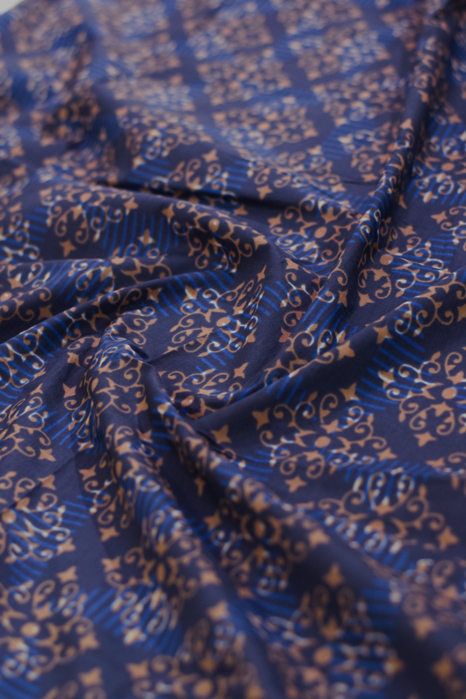 Blue fabric with intricate gold patterns