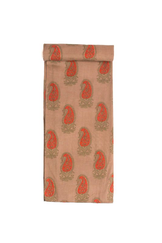 A beige fabric with red paisley motifs and green foliage printed throughout.