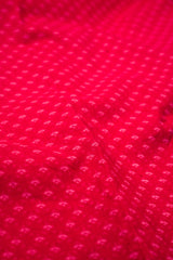 Close-up of red fabric with a subtle pattern