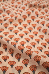 Patterned fabric with orange floral design on a beige background