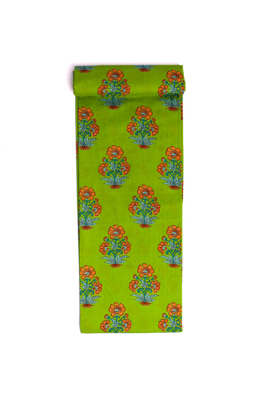 A strip of fabric with a green background and bright orange floral print.