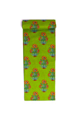 A strip of fabric with a green background and bright orange floral print.
