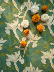 Floral patterned fabric with white flowers on a green background