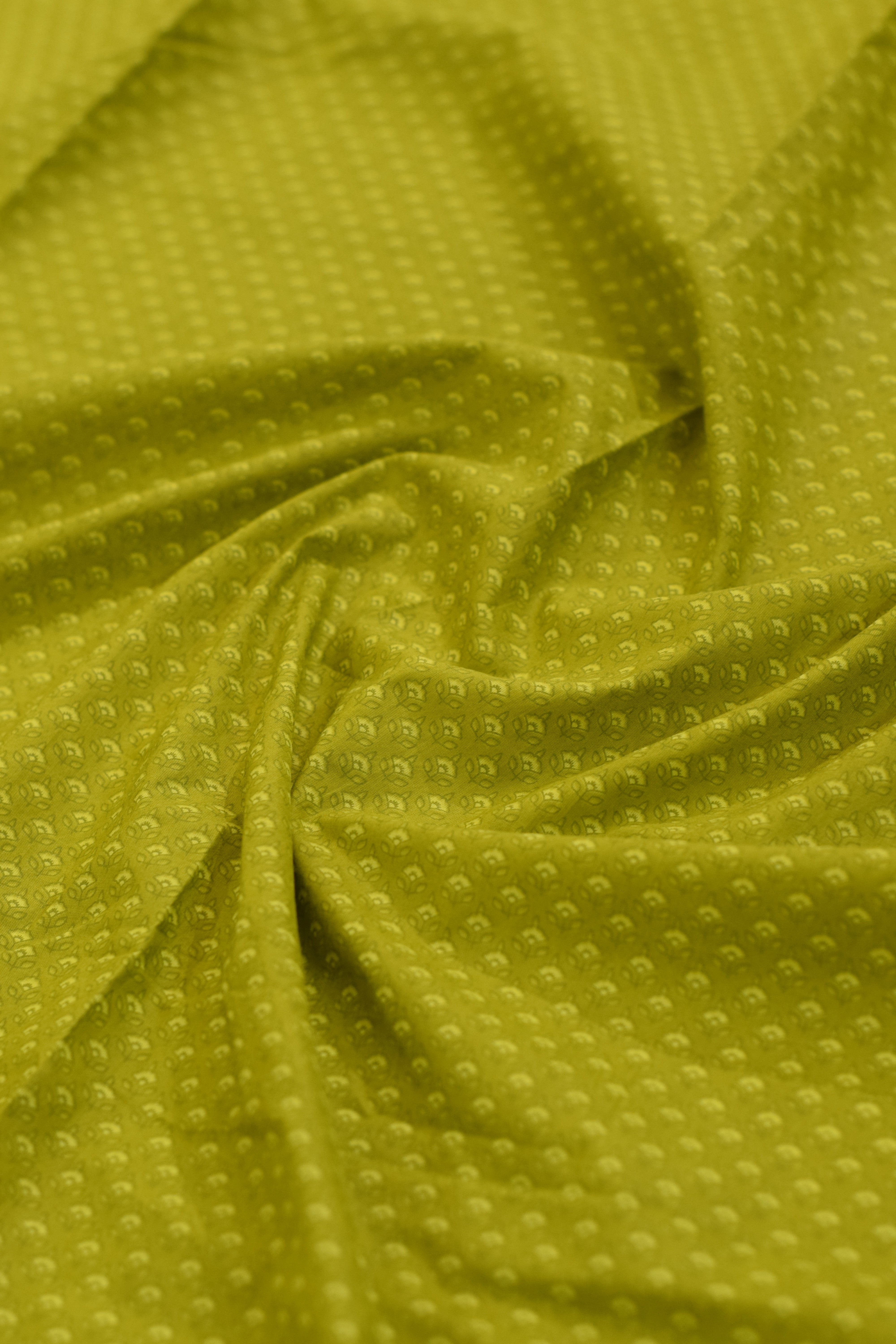 Close-up of green textured fabric with subtle pattern