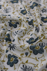 Close-up of floral patterned fabric in white, blue, and gold.