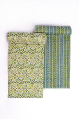 Two pieces of fabric with pastel garden patterns, one in pastel green and the other in a combination of pastel green and lavender, both with geometric designs.