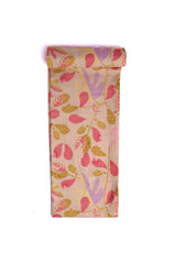 Fabric with an off-white base covered in an abstract print of pastel pink, purple, and beige leaves.