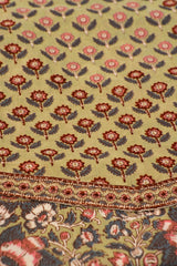 Patterned fabric with floral design on a olive background
