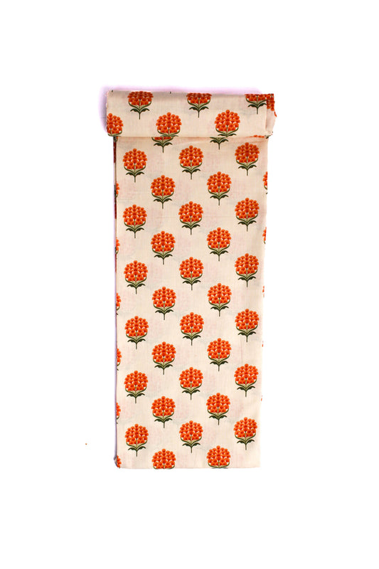 A cream-colored fabric with a pattern of grey floral vines and tangerine orange blooms.