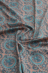 Close-up of paisley-patterned fabric in brown and teal.
