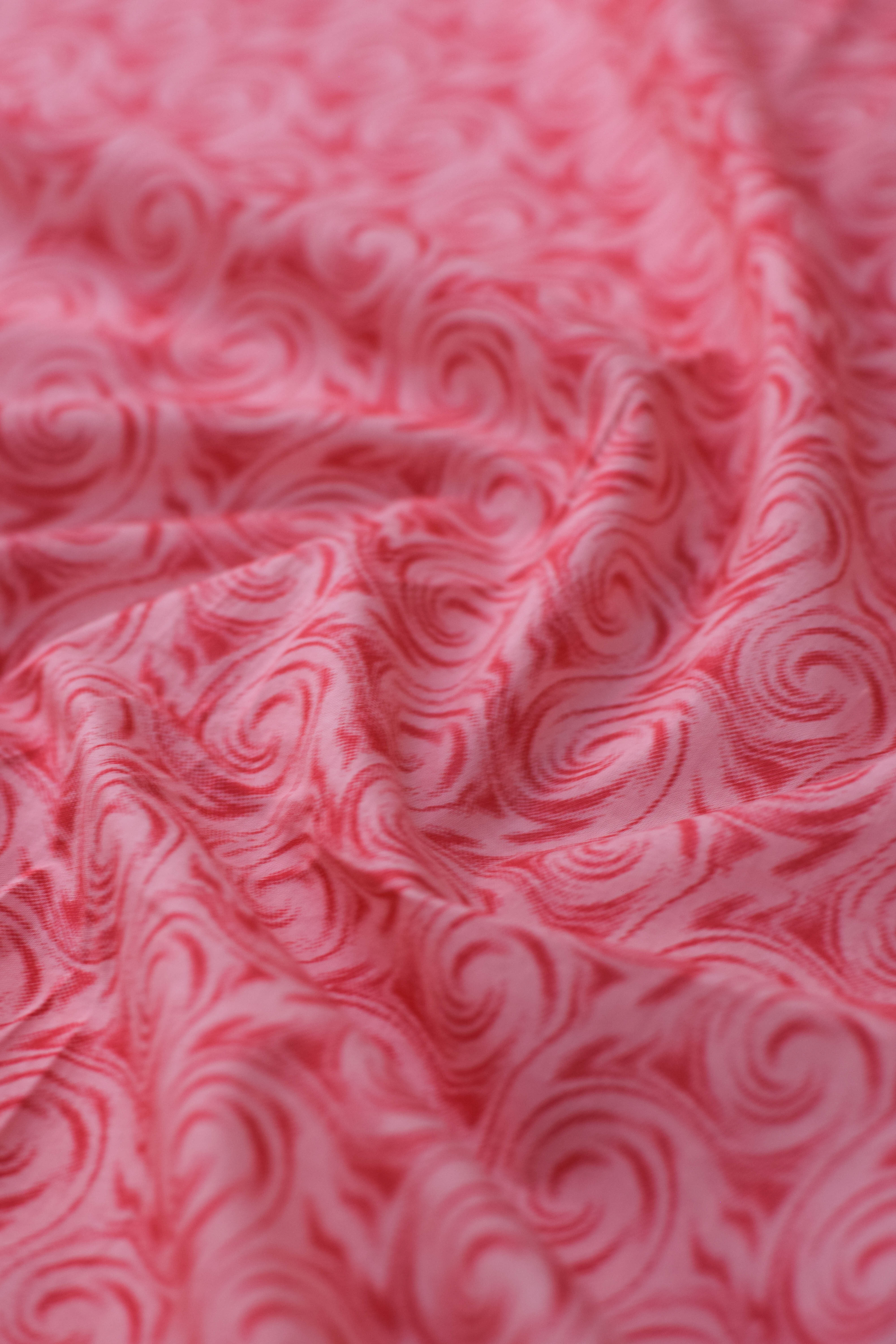 Close-up of red marbled fabric texture.