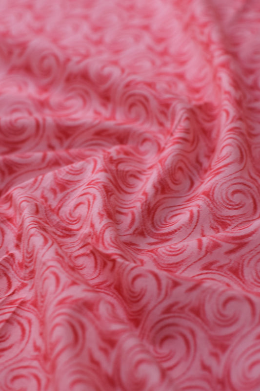 Close-up of red marbled fabric texture.