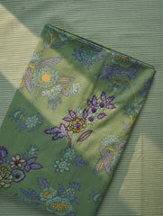 Fabric with floral embroidery on a green textured background