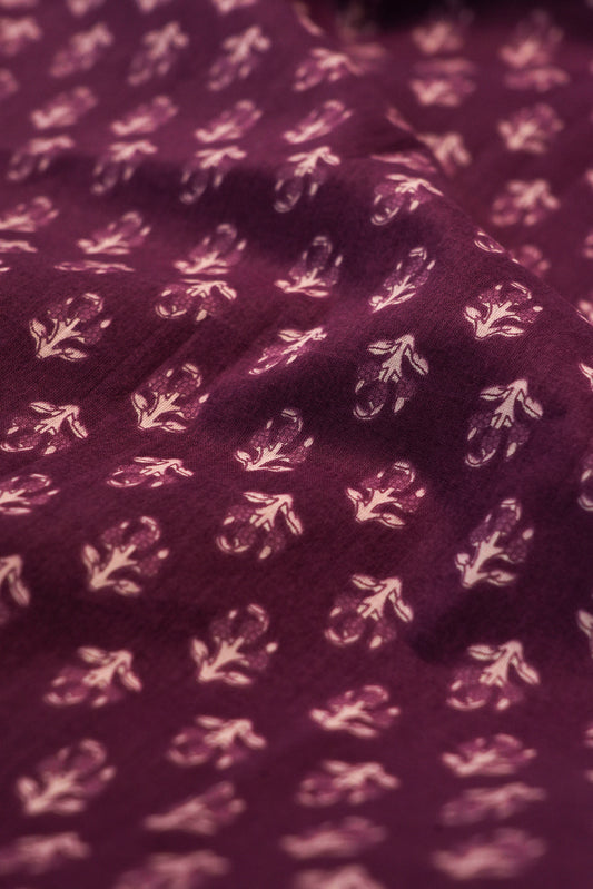 Close-up of a purple fabric with white floral patterns