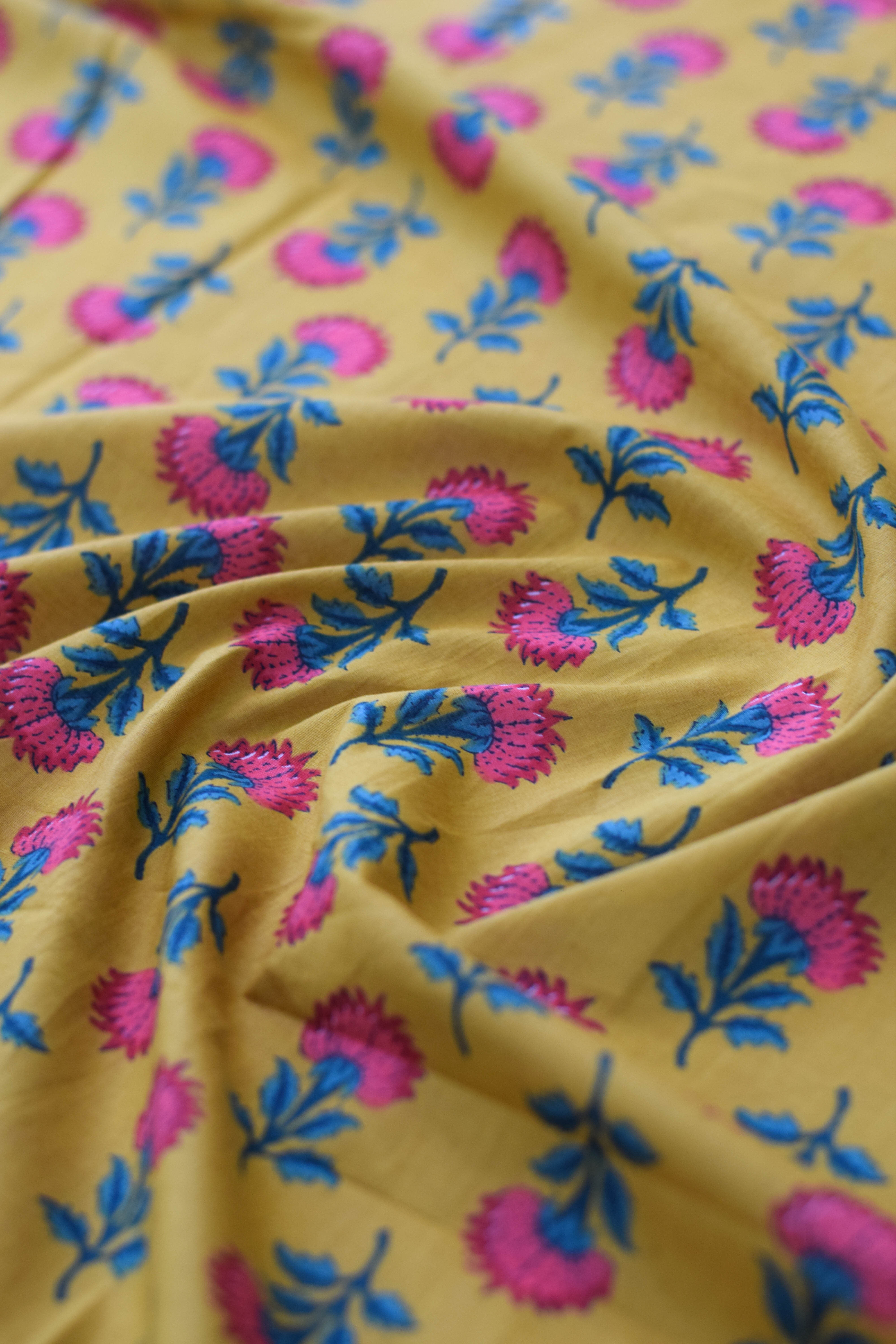 Yellow fabric with pink and blue floral patterns