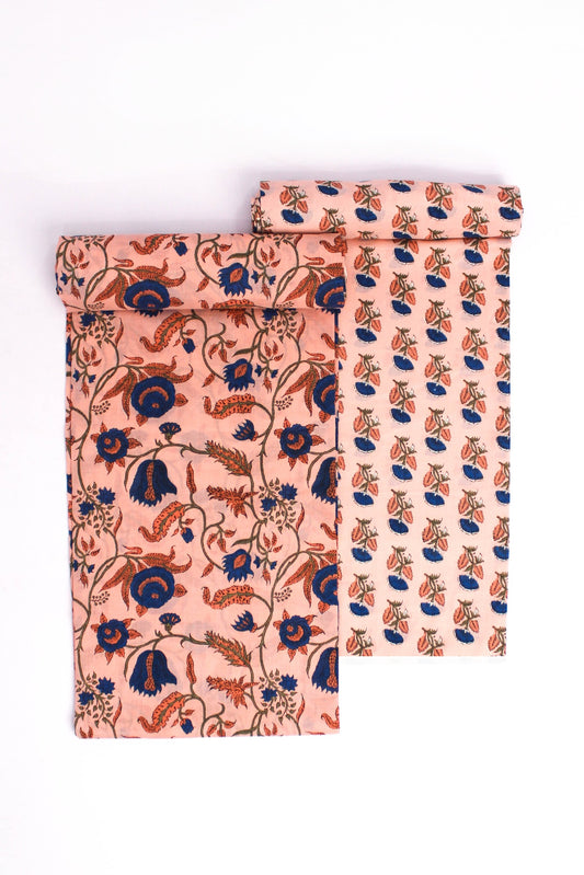 Two pieces of fabric with floral patterns, one featuring a larger floral design on a peach background and the other with a smaller floral design on a darker background.