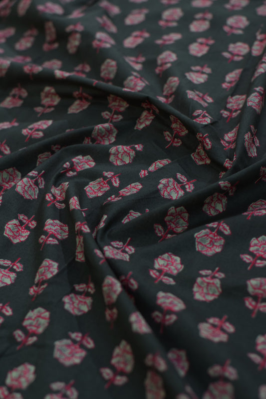 Floral patterned fabric with pink flowers on a dark background