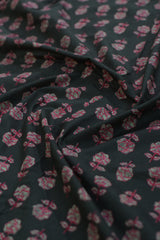 Floral patterned fabric with pink flowers on a dark background