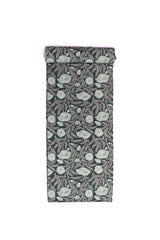 Fabric with a forest green background featuring sketched flowers and leaves in white and lilac.