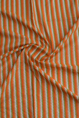 Chevron pattern fabric with orange and green stripes.