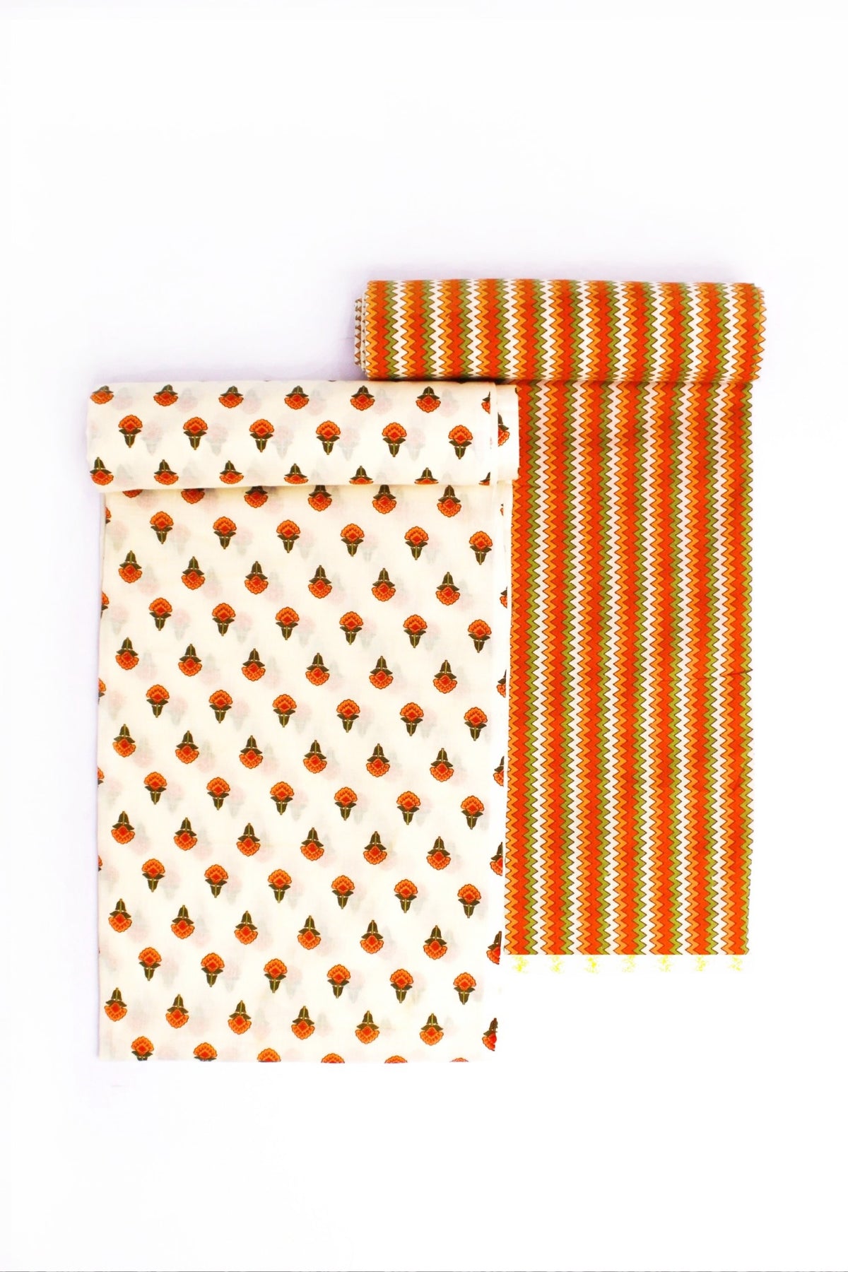 Two pieces of fabric with geometric patterns. One has a series of red and blue diamond shapes on a beige background, and the other has a striped pattern with orange colors.
