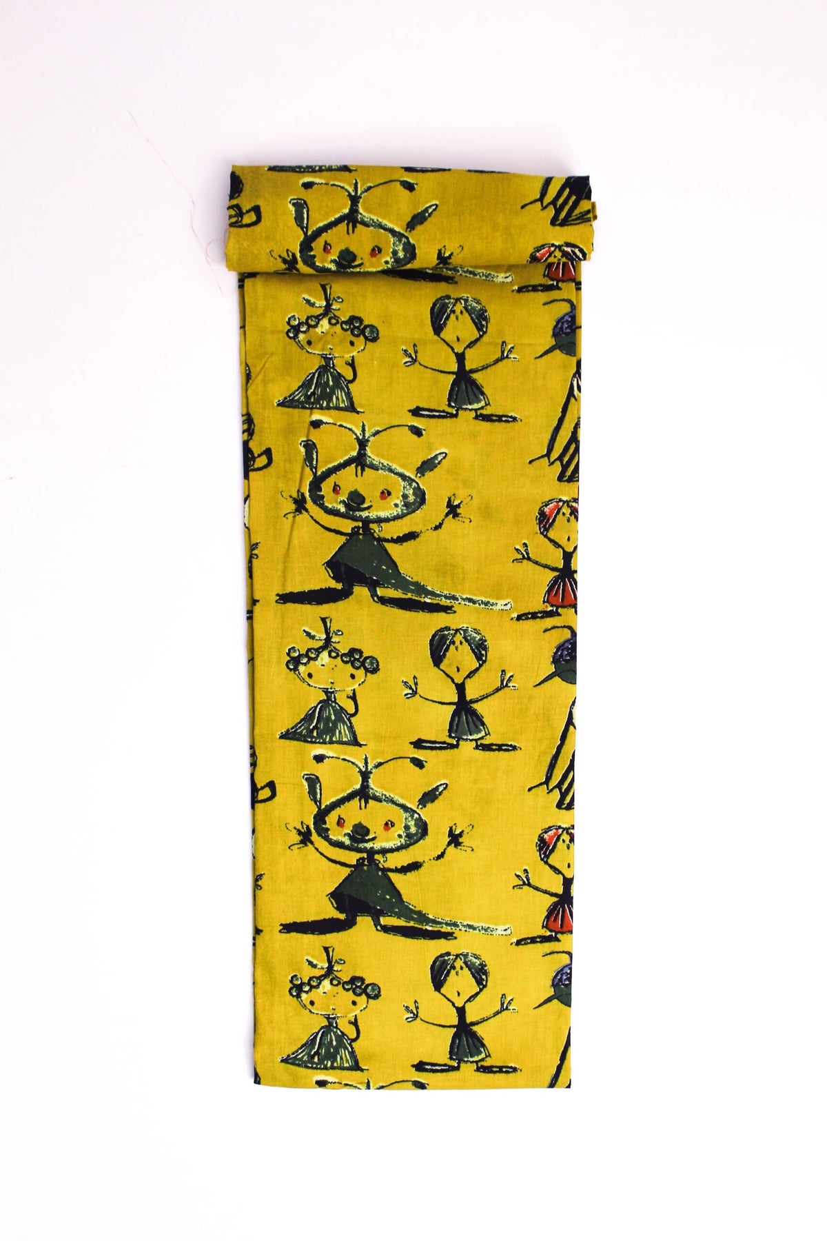 Mustard-yellow fabric with abstract tribal figures printed in red, green, and blue colors