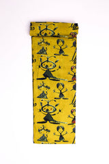 Mustard-yellow fabric with abstract tribal figures printed in red, green, and blue colors