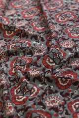 Close-up of paisley patterned fabric in red and gray.