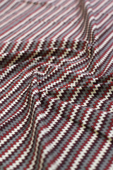 Close-up of zigzag patterned fabric in red, white, and gray.
