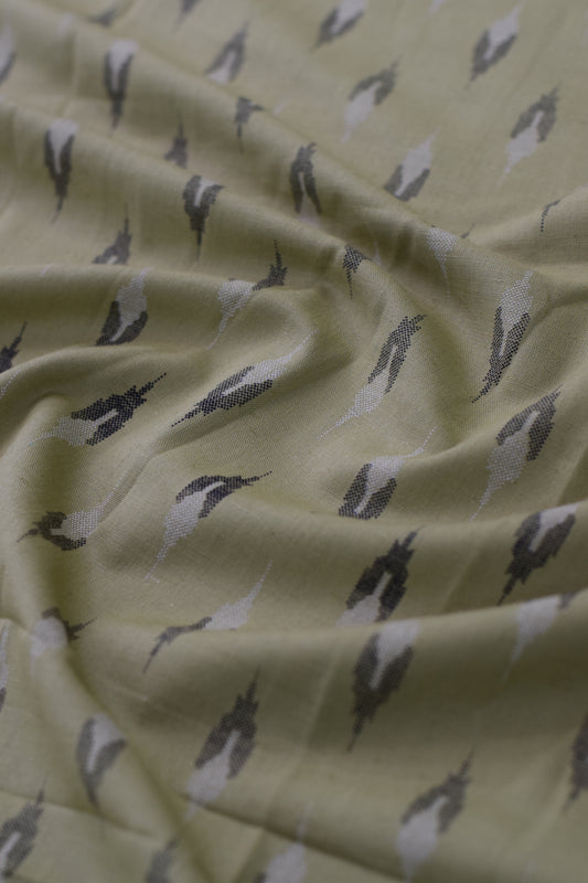 Close-up of fabric with bird pattern on light yellow background