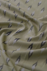 Close-up of fabric with bird pattern on light yellow background