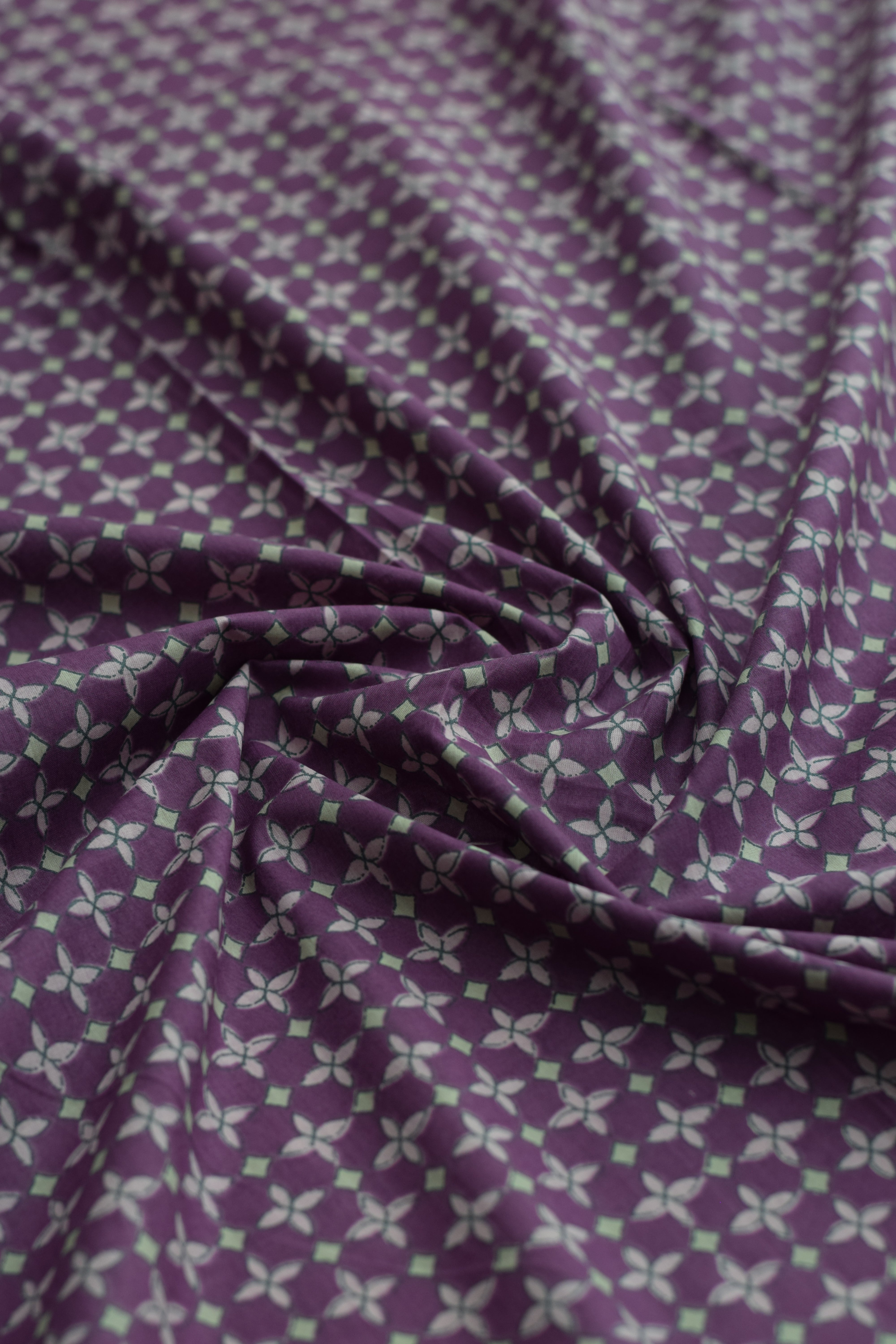 Purple fabric with subtle pattern close-up
