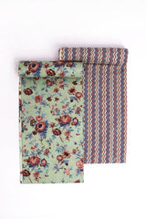 Two fabric pieces, one with a floral pattern and another with a geometric zigzag pattern, likely intended for tailoring into a suit set.