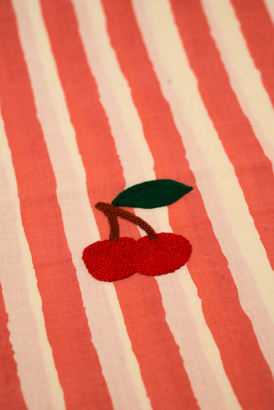 Embroidered cherries on a red and white striped fabric