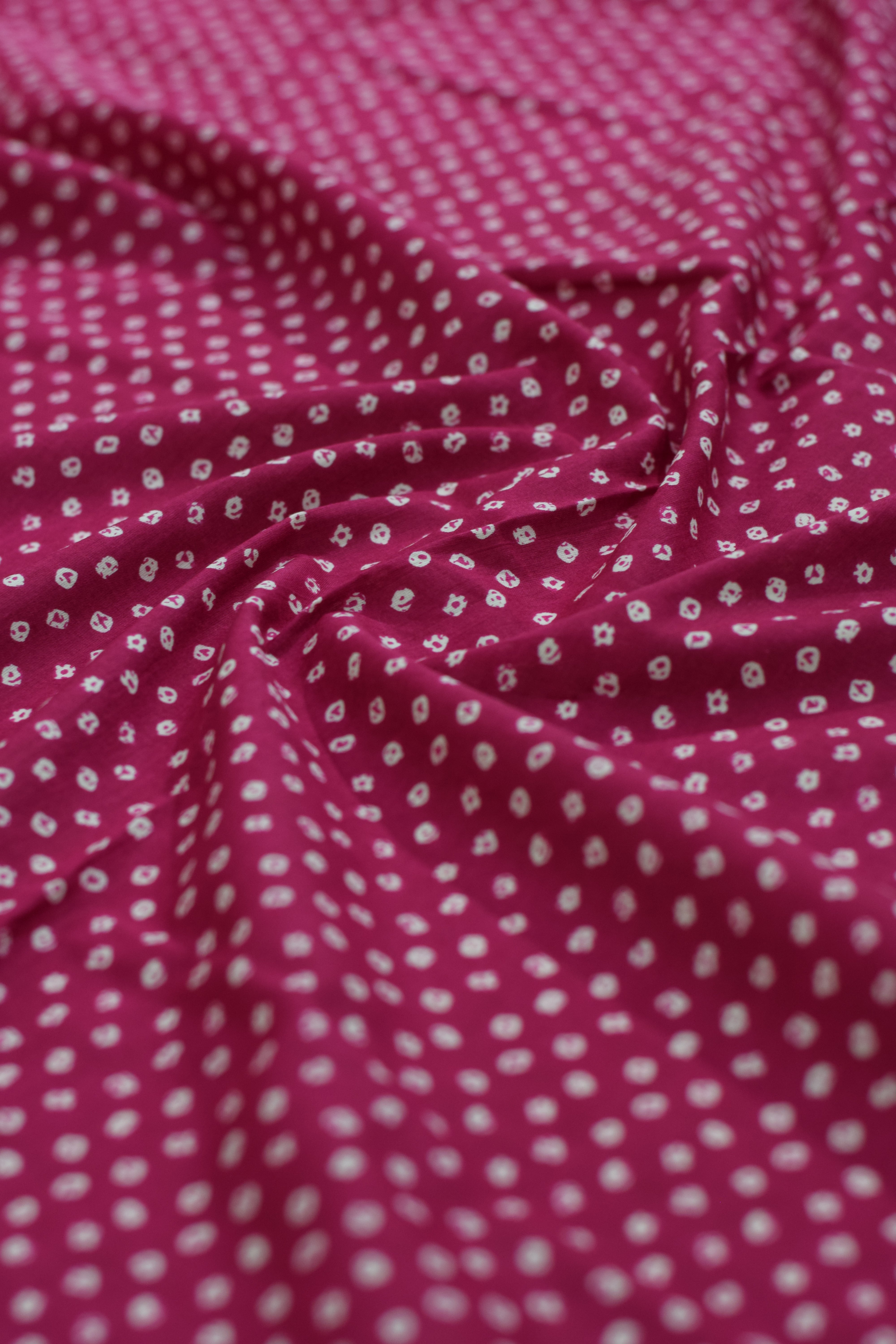 Pink fabric with small white floral pattern