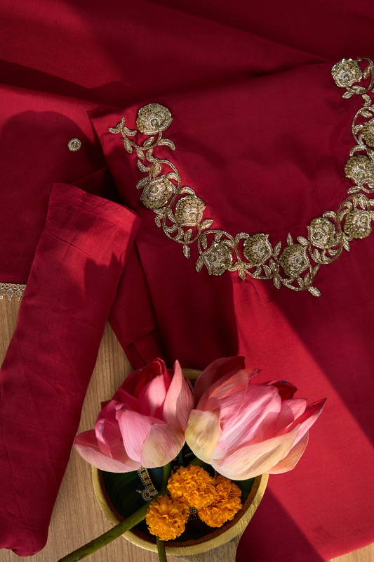 Maroon fabric with intricate silver embroidery