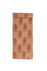 A beige fabric with red paisley motifs and green foliage printed throughout.