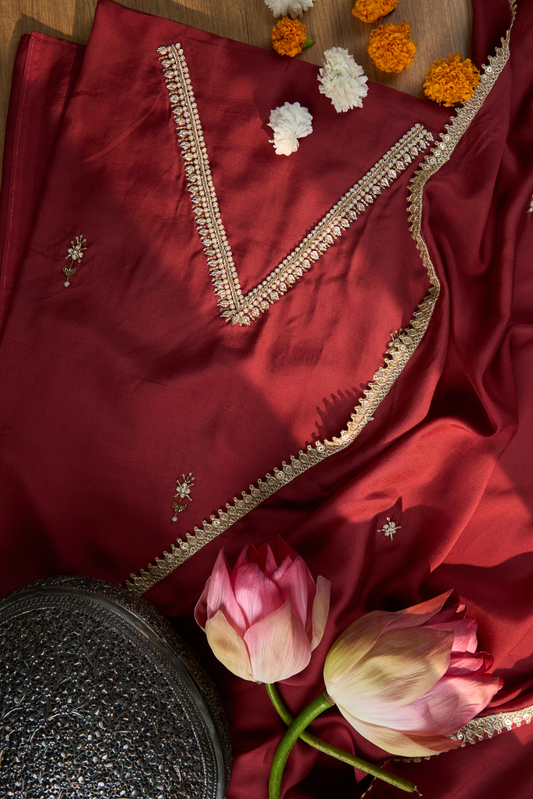 Maroon fabric with intricate gold embroidery