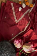 Maroon fabric with intricate gold embroidery