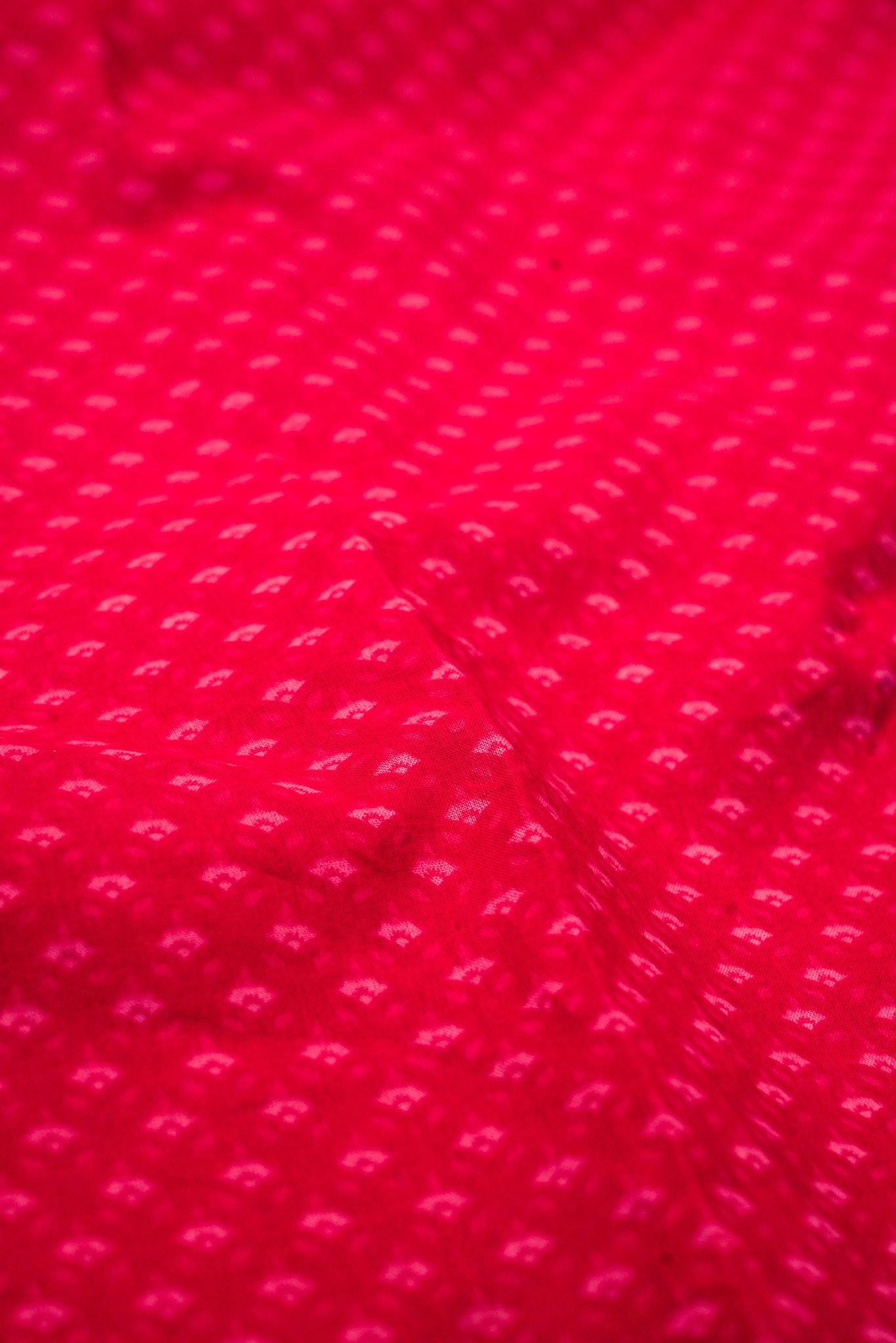 Close-up of red fabric with a subtle pattern