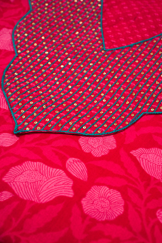 Close-up of a red fabric with floral patterns and embroidery