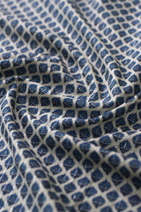 Close-up of patterned fabric with blue and white design