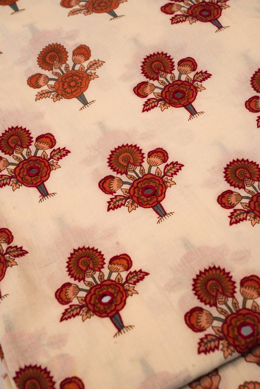 Patterned fabric with red floral designs on a beige background