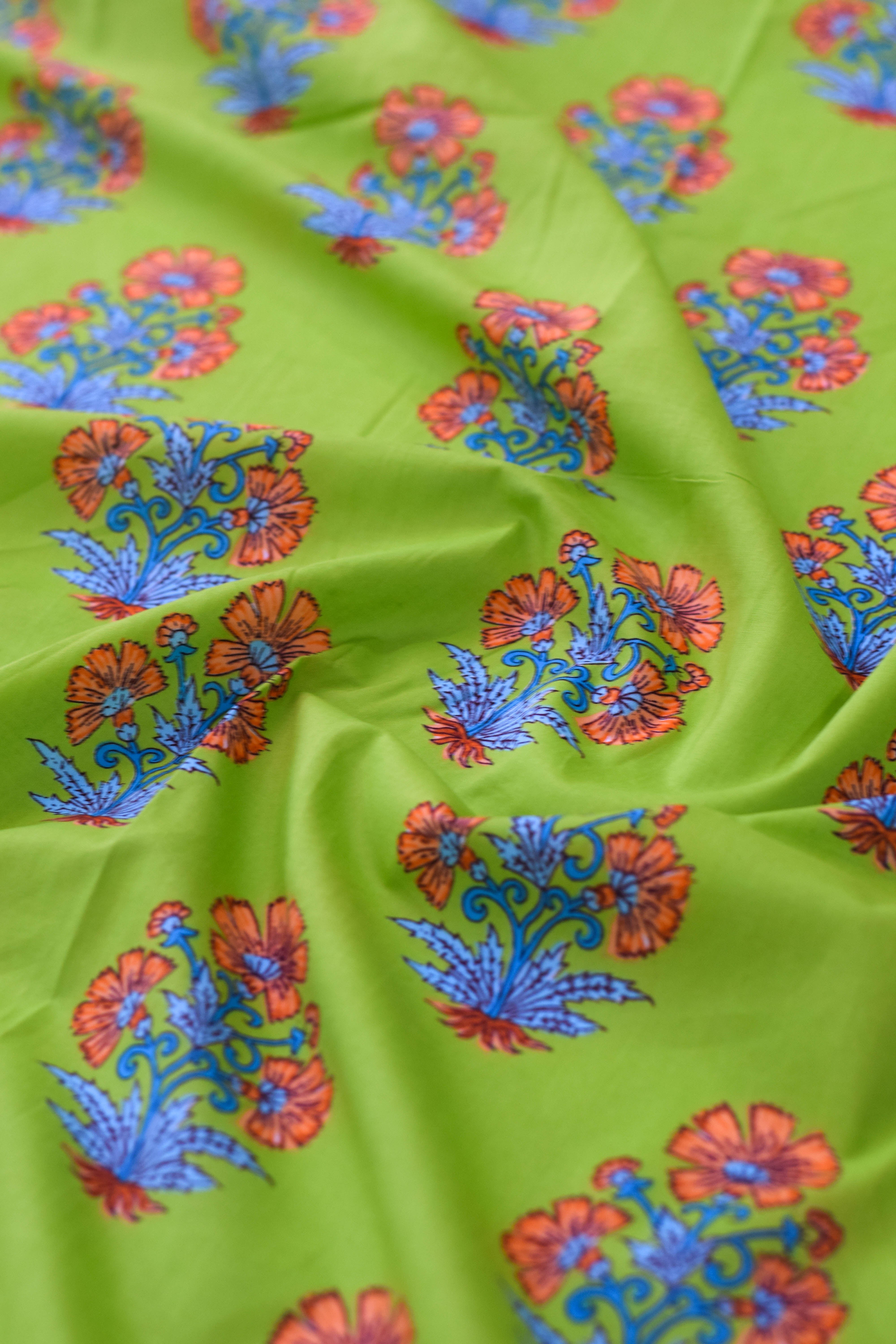 Green fabric with orange and blue floral patterns