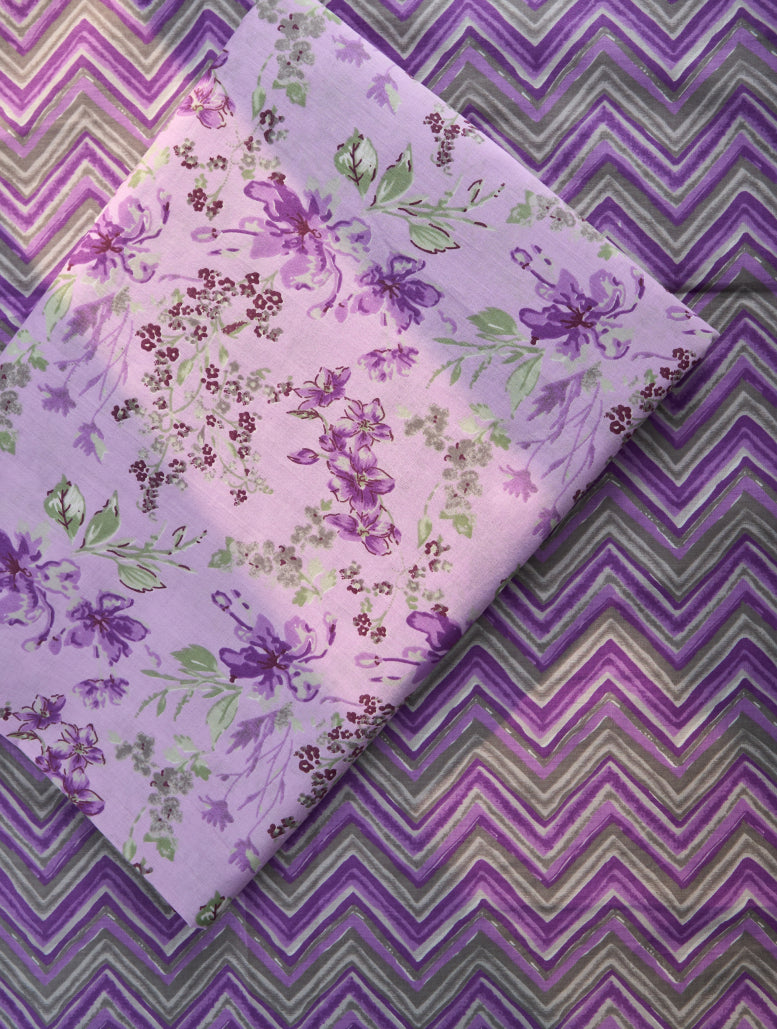 Floral fabric with purple and green pattern on a zigzag background