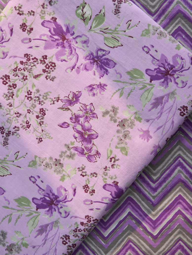 Two pieces of purple fabric with floral and zigzag patterns.