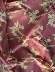 Close-up of pinkish-purple fabric with white floral pattern